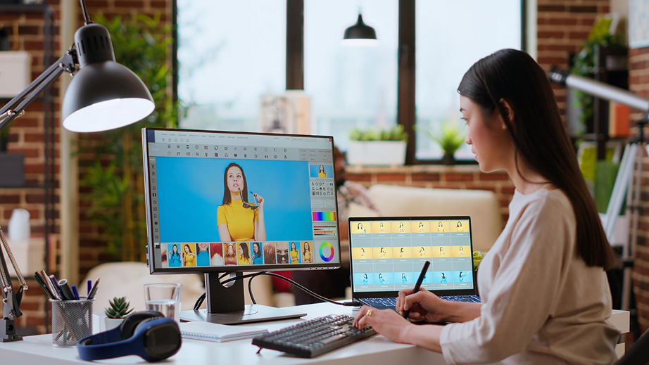 Learner working on a creative design setup with dual screens